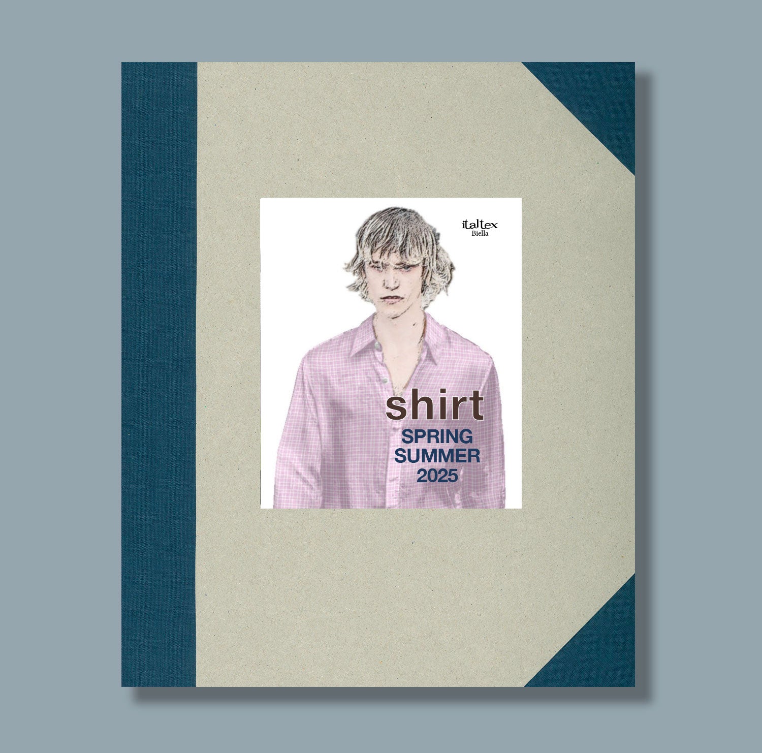 The cover of the Italtex fabric and color trend book Shirt Spring/Summer 2025 is a hardback cover in natural cardboard with dark blue canvas decorations along the spine and covering the corners. In the middle there is a picture showing a man wearing a shirt made with one of the fabrics contained in the book. It is a subdued small repeat check