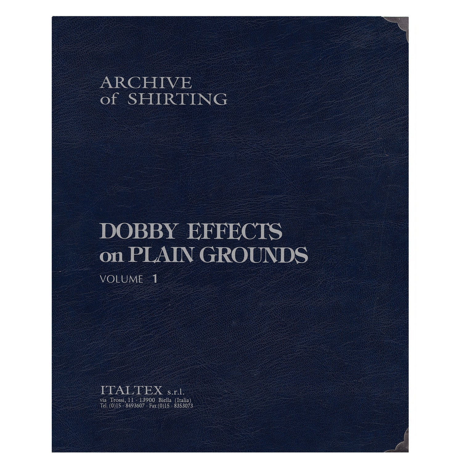 Blue, hardback leather-like cover  on which is written: Archive of Shirting, Dobby Effects on Plain Grounds Volume 1, Italtex Srl, Via Trossi, 11 - 13900 Biella Italy of the Italtex photographic book 